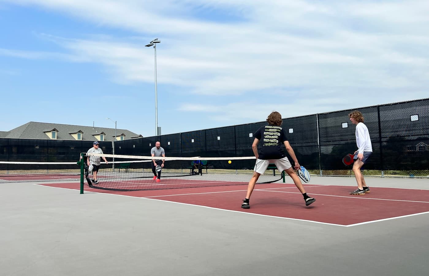 Pickleball player stepping into the non-volley zone to play a bounced ball