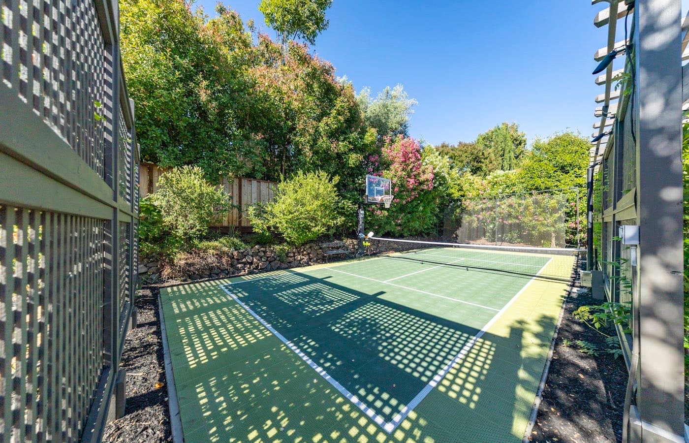 Indoor sports hall set up with a portable pickleball net and taped court lines