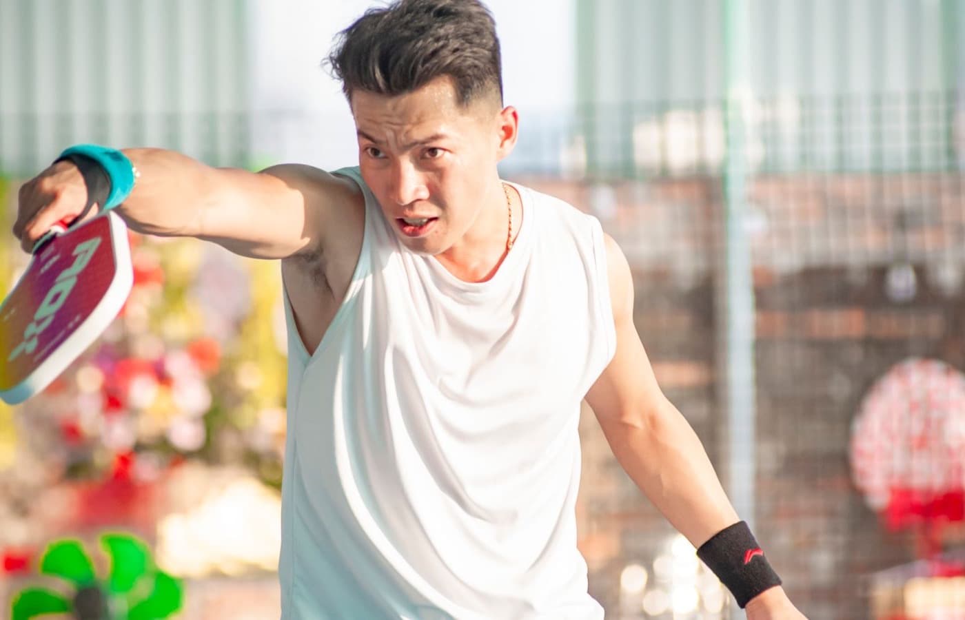 Player swinging a pickleball paddle during a rally
