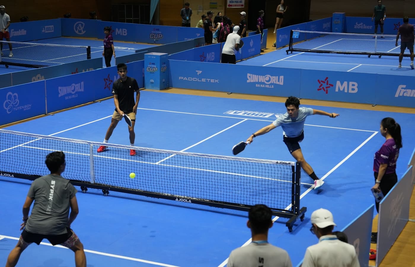 Pickleball player calling the score before serving on an indoor court